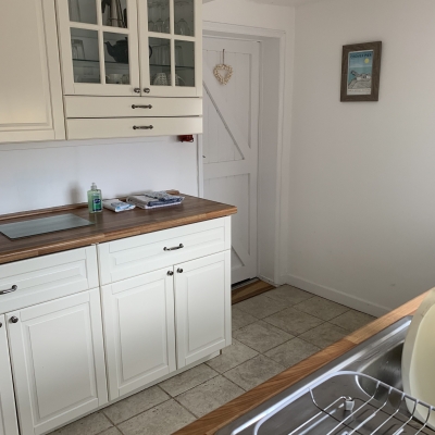 Kitchen with door leading to the living room